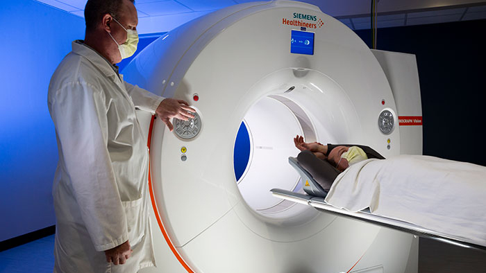 Radiology technician performing a can