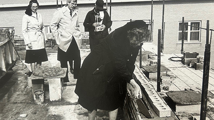 Sister laying brick