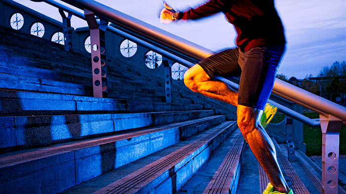 Man running up bleacher steps