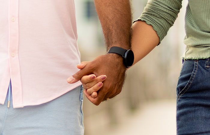 young black man holding hands with a young woman