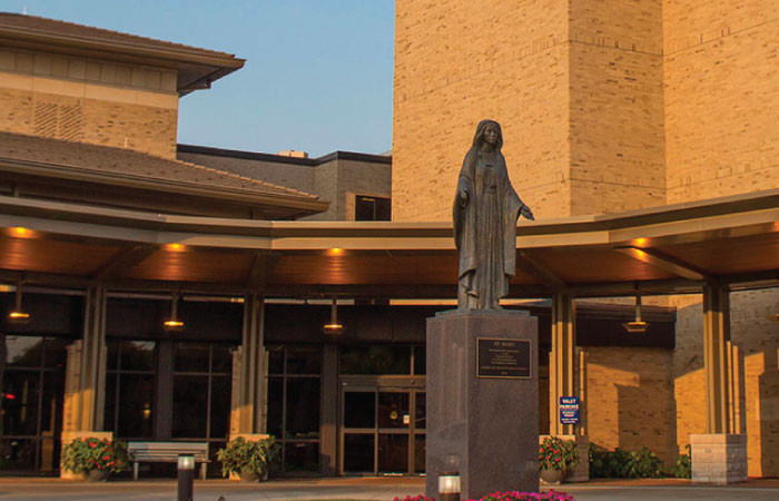 Exterior of HSHS St. Mary's Hospital Medical Center. St. Mary's statue in front of the valet service doors. 