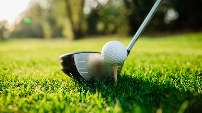 Golf ball teed up on golf course