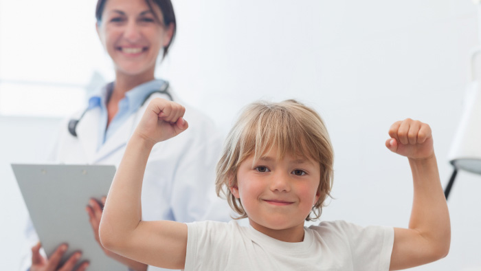 Young boy flexing his muscles