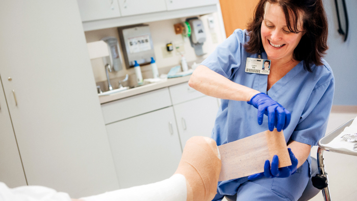 Nurse wrapping a foot in bandages