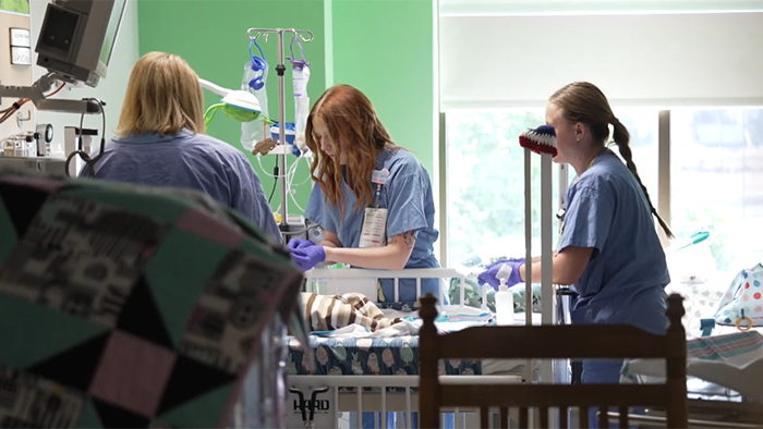 Madalynn working on patient with two other nurses