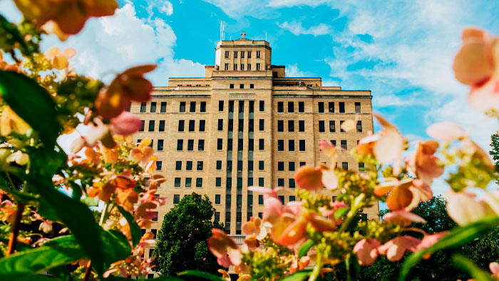 Front exterior of HSHS St. John's Hospital with flowers in foreground