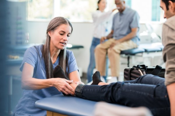 doctor working with ankle patient