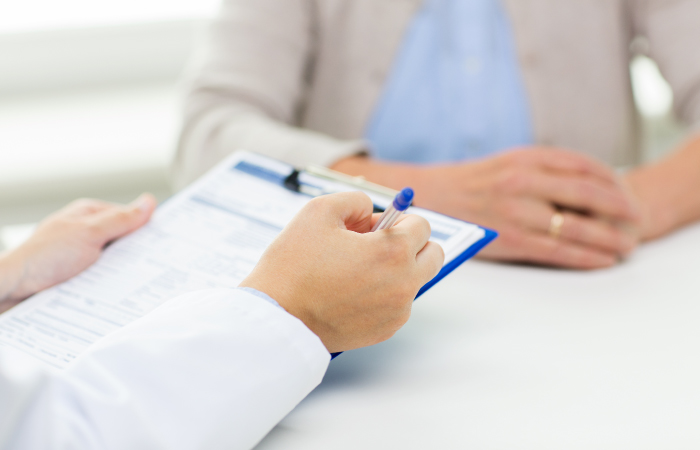 Doctor going over forms with patient