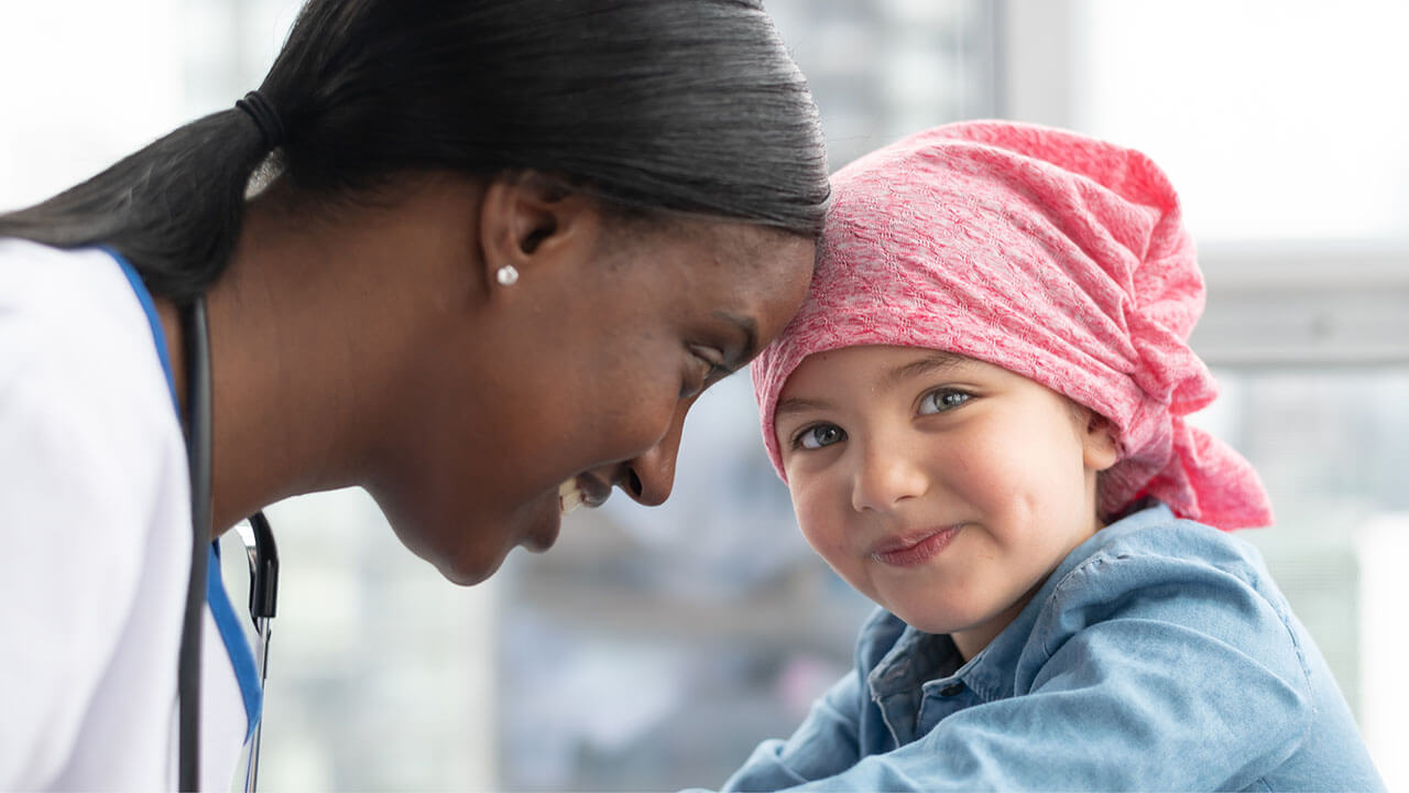Diverse care team surrounds young girl patient as they provide care