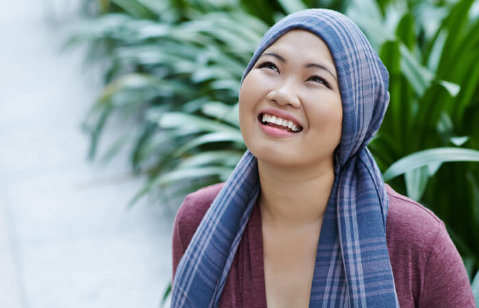 women in a head scarf smiling