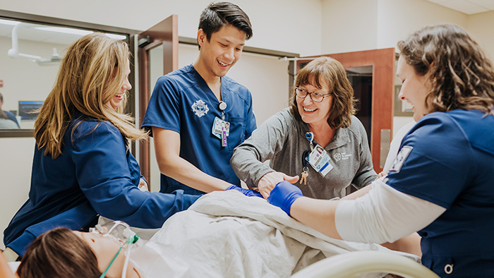 Nursing instructor showing students a procedure