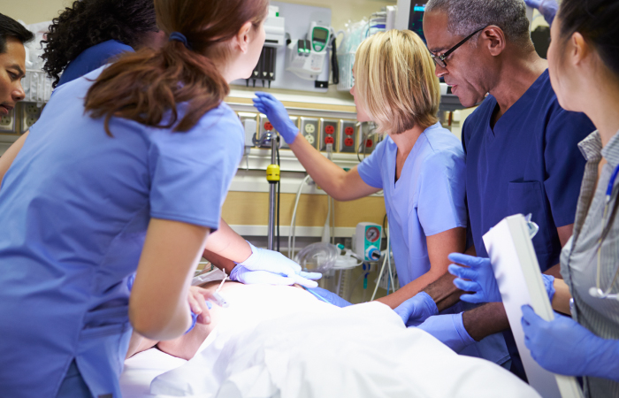 Diverse care team surrounds patient as they provide care