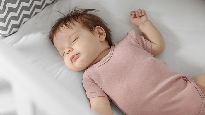 Infant practicing safe sleep