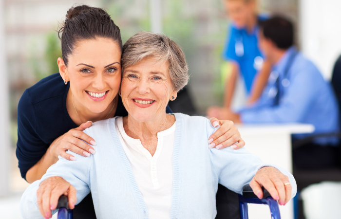 Woman hugging another woman in wheelchair