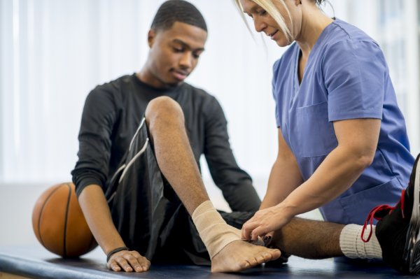 doctor working on ankle of sports injury