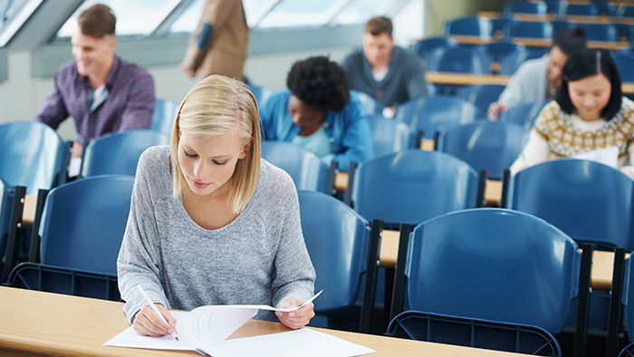 Students in a lecture class working on papers