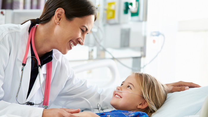 Female doctor comforting a young girl patient