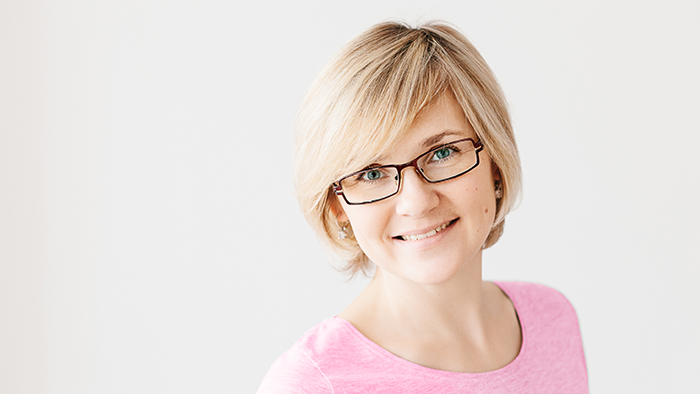 Young woman in pink smiling 