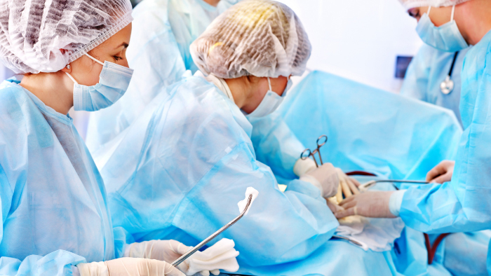 Surgery scene with technicians, nurses and surgeons