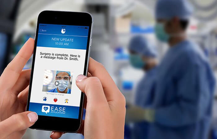 Patient using EASE mobile app on cell phone with an operating room in the background 