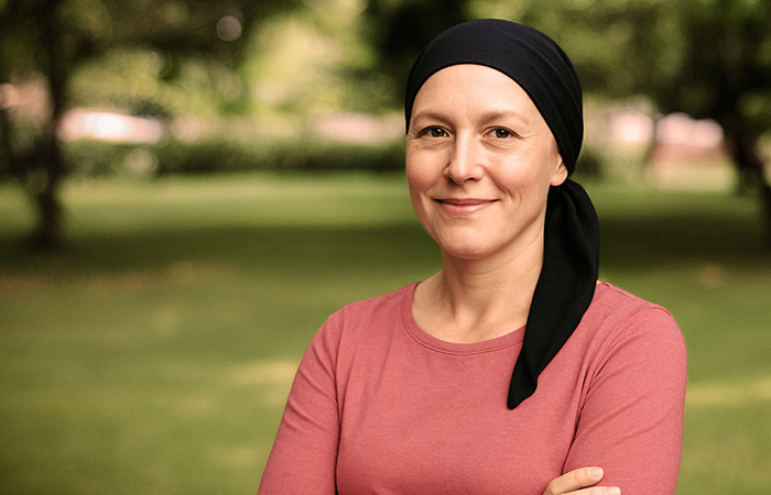 Cancer patient standing in a park