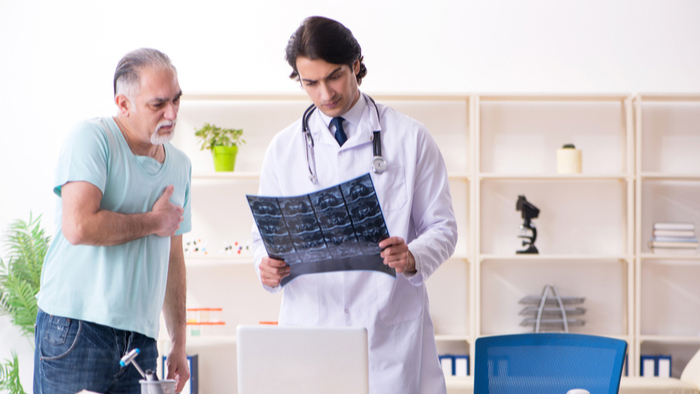 Male doctor evuating scan with patient