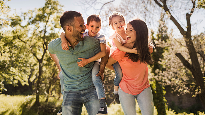 Young family of four laughing together