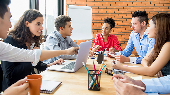 A group of people around a conference table