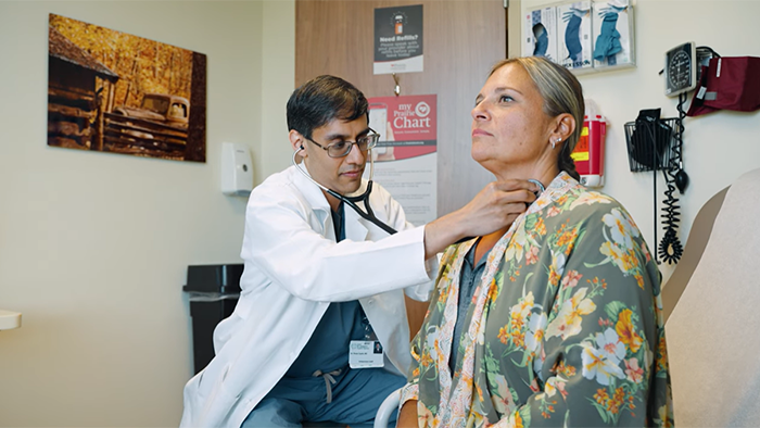 doctor listening to patients heart rate