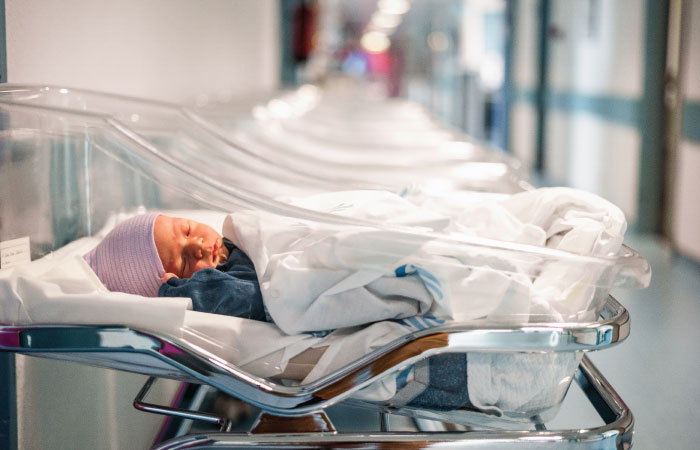infant in a nicu bed in the hospital