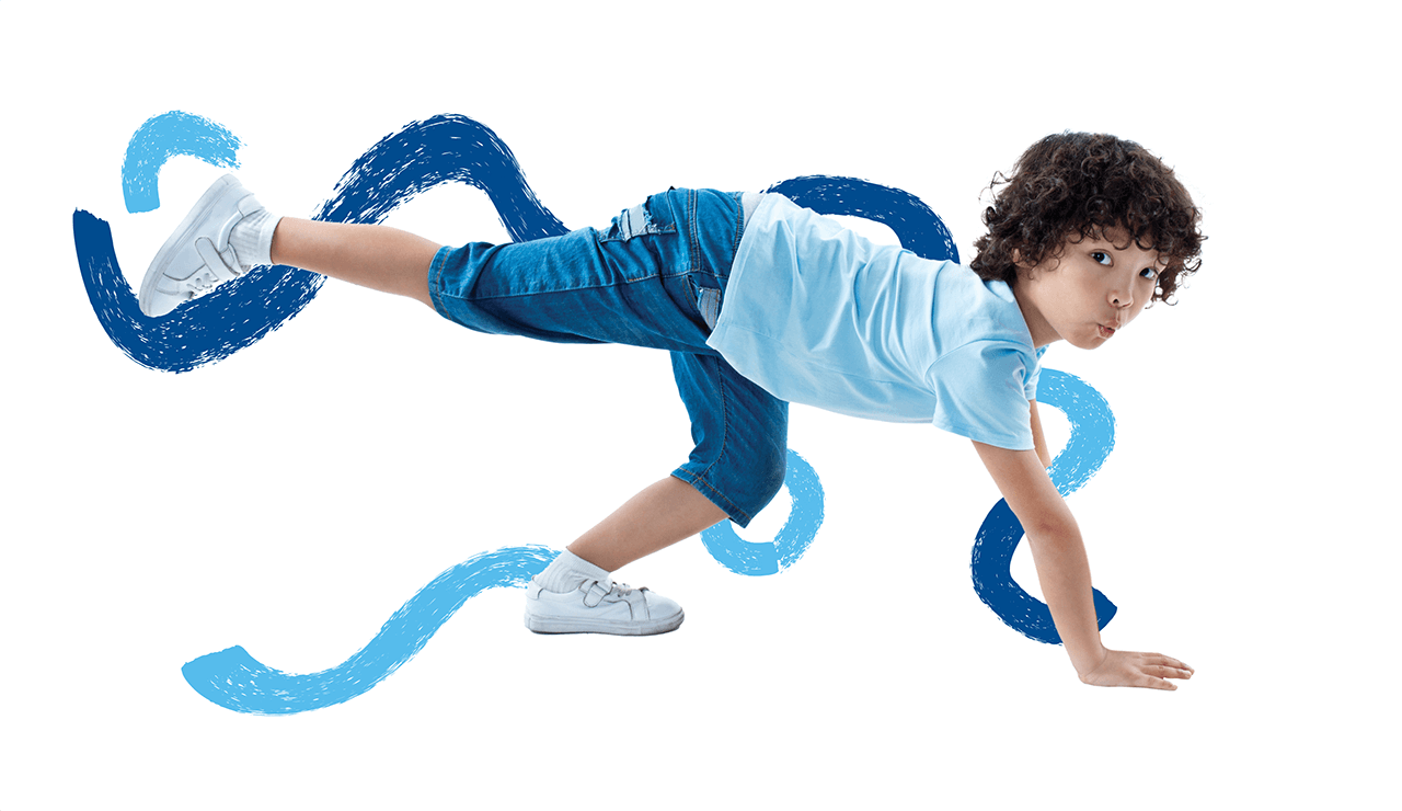 Blue crayon marks behind a young boy wearing blue top and pants