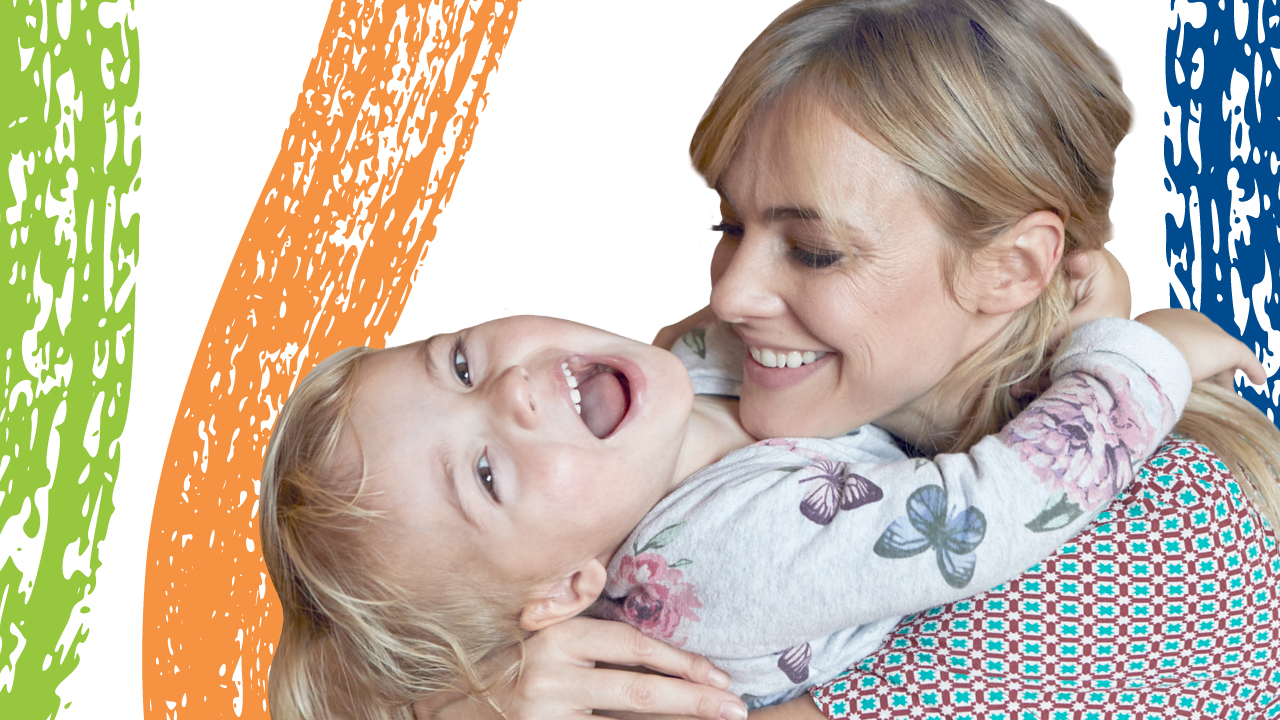 child dancing in front of a background painted with swirls