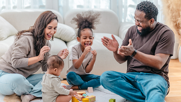 A family enjoying a game on the floor