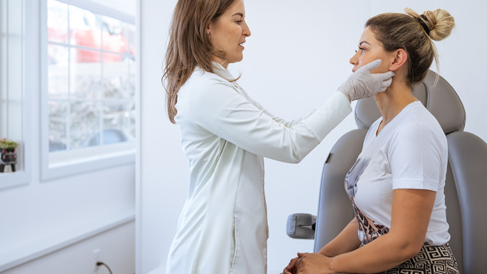doctor examining womans face