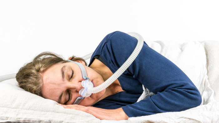 Woman sleeping with a CPAP device
