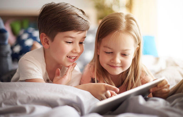 young boy and girl looking through a picture book together