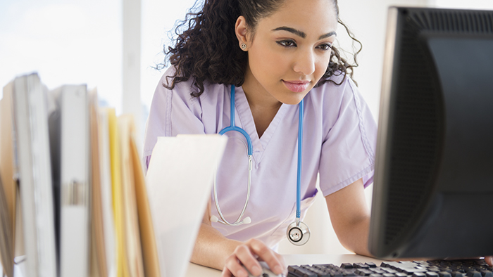 A young nurse on a computer