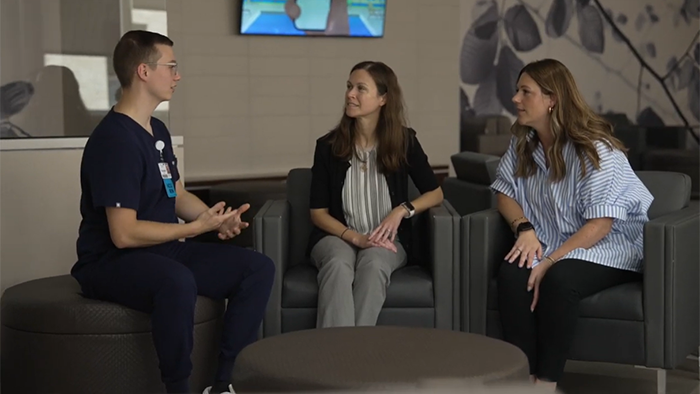 Braden talking to two HSHS colleagues