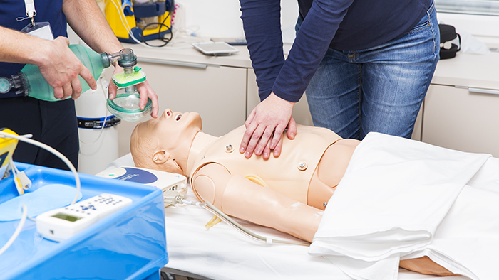 Practicing CPR on mannequin