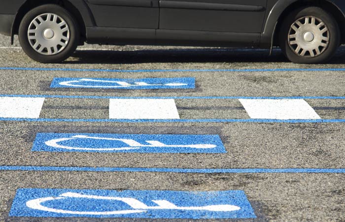 Looking down at blue handicap parking spaces