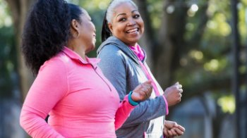 African-American women walking in a park.