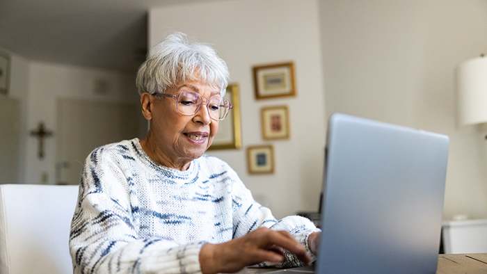 Senior woman using a laptop computer at home