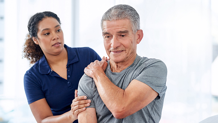 Man working on shoulder with therapist