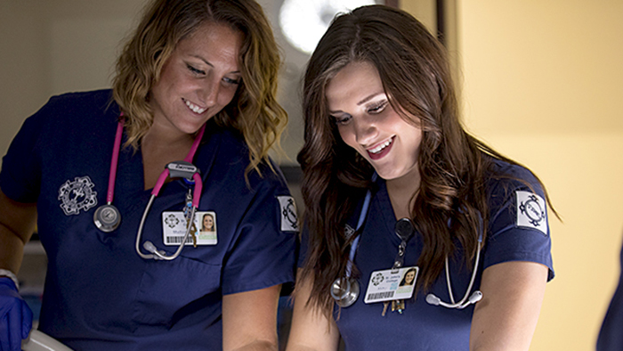 Two nursing students working together