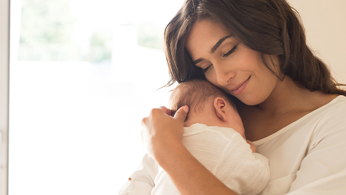 Mom cuddling infant