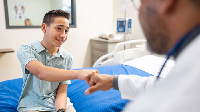 Young man fist bumping his therapist