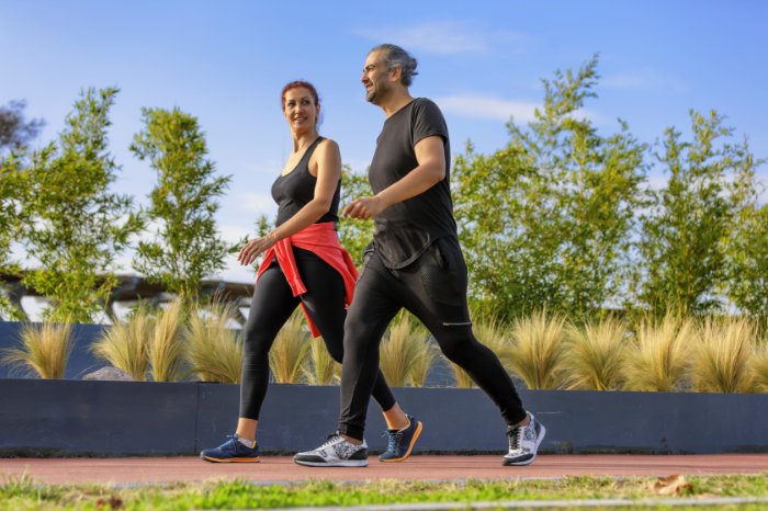 Two people walking in step