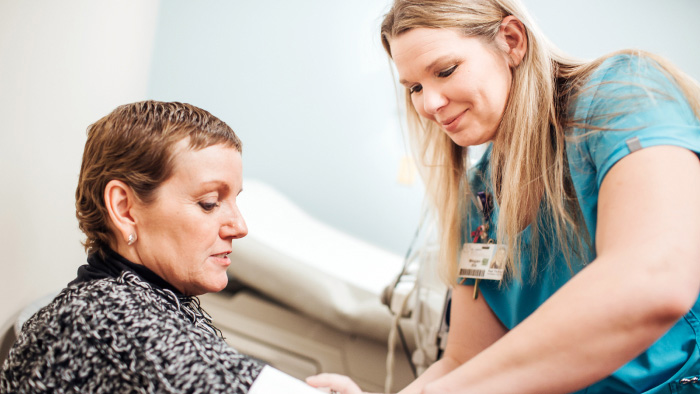 Woman with nurse preparing for treatment