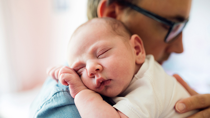 Dad holding infant baby