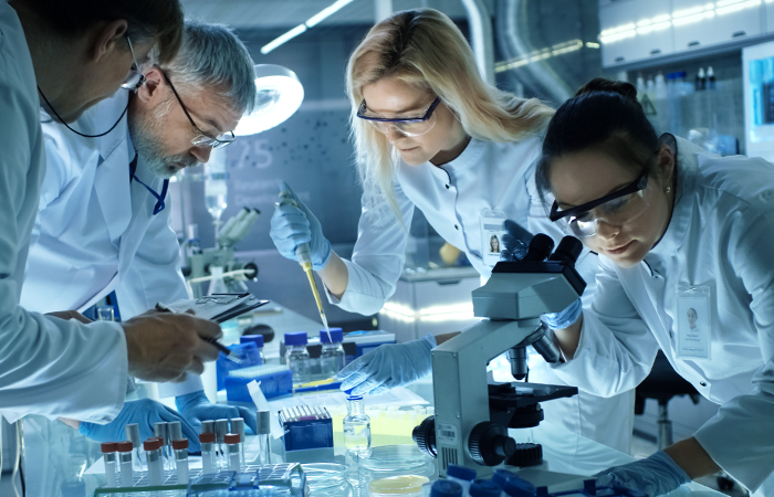 group of geneticists doing lab work at a hospital 
